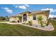 Front view of a yellow single-story house with landscaping at 233 Marker Rd, Rotonda West, FL 33947