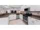 Well-equipped kitchen with stainless steel appliances and granite countertops at 233 Marker Rd, Rotonda West, FL 33947