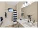 Bathroom with a bathtub, shower, and modern vanity at 26866 Weiskopf Dr, Englewood, FL 34223