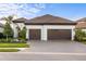 White one-story house with brown tile roof, two-car garage, and landscaped front yard at 26866 Weiskopf Dr, Englewood, FL 34223