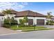 Single-story home with tile roof, two-car garage, and landscaped yard at 26866 Weiskopf Dr, Englewood, FL 34223