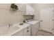 Laundry room with washer, dryer, sink, and cabinets at 26866 Weiskopf Dr, Englewood, FL 34223