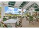 Relaxing outdoor dining area overlooking a golf course at 26866 Weiskopf Dr, Englewood, FL 34223