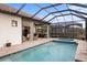 Resort-style pool with spa, outdoor kitchen, and covered patio at 26866 Weiskopf Dr, Englewood, FL 34223