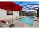 Enjoy this luxurious pool and spa with a covered patio and lounge chairs at 26866 Weiskopf Dr, Englewood, FL 34223