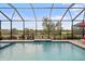 Inviting pool and spa with water feature and preserve views at 26866 Weiskopf Dr, Englewood, FL 34223