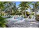 Resort-style pool deck featuring numerous lounge chairs at 26866 Weiskopf Dr, Englewood, FL 34223