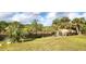 Serene backyard with lush landscaping and canal view at 328 Baytree Dr, Rotonda West, FL 33947