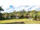 Peaceful backyard oasis with a canal view and lush tropical landscaping at 328 Baytree Dr, Rotonda West, FL 33947