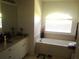 Clean bathroom with a soaking tub and updated vanity at 328 Baytree Dr, Rotonda West, FL 33947