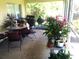 Screened lanai with outdoor furniture and tropical plants at 328 Baytree Dr, Rotonda West, FL 33947