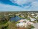 Aerial view of a single-Gathering home near a lake at 3302 Bluejay Ln, Englewood, FL 34224