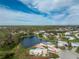 Aerial view of a house by the lake in a quiet neighborhood at 3302 Bluejay Ln, Englewood, FL 34224