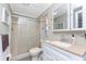 Clean bathroom with shower stall, toilet, and vanity with a white cabinet at 3302 Bluejay Ln, Englewood, FL 34224