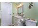 Bathroom with toilet and vanity with a white cabinet at 3302 Bluejay Ln, Englewood, FL 34224