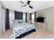 Bedroom with a queen-size bed, dresser, and TV at 3302 Bluejay Ln, Englewood, FL 34224