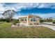 Tan single-story home with landscaping and driveway at 3302 Bluejay Ln, Englewood, FL 34224