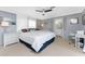 Spacious main bedroom with a king-size bed and access to a patio at 3302 Bluejay Ln, Englewood, FL 34224