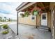 Covered patio with hanging flower baskets and exterior access at 3302 Bluejay Ln, Englewood, FL 34224