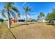 Spacious backyard featuring a large grassy area and palm trees at 3460 Lullaby Rd, North Port, FL 34287