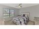 Spacious bedroom with a ceiling fan and large window at 3460 Lullaby Rd, North Port, FL 34287