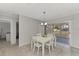 Dining area with white table and chairs, access to patio at 3460 Lullaby Rd, North Port, FL 34287