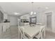 White cabinets and a kitchen island highlight this eat-in kitchen at 3460 Lullaby Rd, North Port, FL 34287