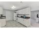 This galley kitchen boasts white cabinets and dark countertops at 3460 Lullaby Rd, North Port, FL 34287