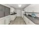 White cabinets and dark countertops in this galley-style kitchen at 3460 Lullaby Rd, North Port, FL 34287