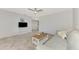 Living room with gray sofa, coffee table, and TV stand at 3460 Lullaby Rd, North Port, FL 34287