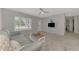 Living room with gray couch and view of hallway at 3460 Lullaby Rd, North Port, FL 34287