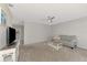 Living room with gray sofa, coffee table and TV at 3460 Lullaby Rd, North Port, FL 34287