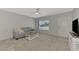 Living room with gray sofa, coffee table, and ceiling fan at 3460 Lullaby Rd, North Port, FL 34287