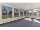 Sunroom with grey carpet, ceiling fan and view of backyard at 3460 Lullaby Rd, North Port, FL 34287