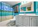 Clean bathroom with white vanity, teal walls, and a shower/tub at 66 Boundary Blvd # 271, Rotonda West, FL 33947