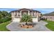 Luxury three-story home with circular driveway and lush landscaping at 710 Albee W Rd, Nokomis, FL 34275