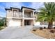 Stunning three-story home with circular driveway and palm tree accent at 710 Albee W Rd, Nokomis, FL 34275