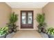 Front entry with double doors and potted plants at 710 Albee W Rd, Nokomis, FL 34275