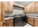 Laundry room with granite countertops, Samsung washer and dryer, and ample cabinet space at 710 Albee W Rd, Nokomis, FL 34275