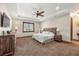 Spacious main bedroom with carpeted floor, ceiling fan, and large window at 710 Albee W Rd, Nokomis, FL 34275