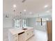 Modern kitchen with island, stainless steel appliances, and white cabinetry at 7330 Printer St, Port Charlotte, FL 33981