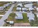 Aerial view of manufactured home community with roads and pond at 735 Summersea Ct, Englewood, FL 34223