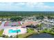 Aerial view of community with pool, tennis courts, clubhouse, and lush landscaping at 735 Summersea Ct, Englewood, FL 34223