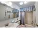 Bathroom with tub, shower, and updated vanity at 735 Summersea Ct, Englewood, FL 34223