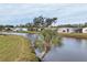 Peaceful waterfront view with lush landscaping and canal at 735 Summersea Ct, Englewood, FL 34223