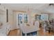 Bright dining area with white table and chairs, near living room at 735 Summersea Ct, Englewood, FL 34223