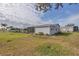 Home's exterior showcases a well-maintained lawn and screened porch at 735 Summersea Ct, Englewood, FL 34223