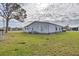 Single-wide manufactured home with white siding and green lawn at 735 Summersea Ct, Englewood, FL 34223