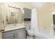 Clean bathroom with a bathtub, shower, and vanity at 7379 Rosemont Dr, Englewood, FL 34224