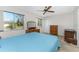 Bright bedroom with a queen bed, dresser, and window views at 7379 Rosemont Dr, Englewood, FL 34224